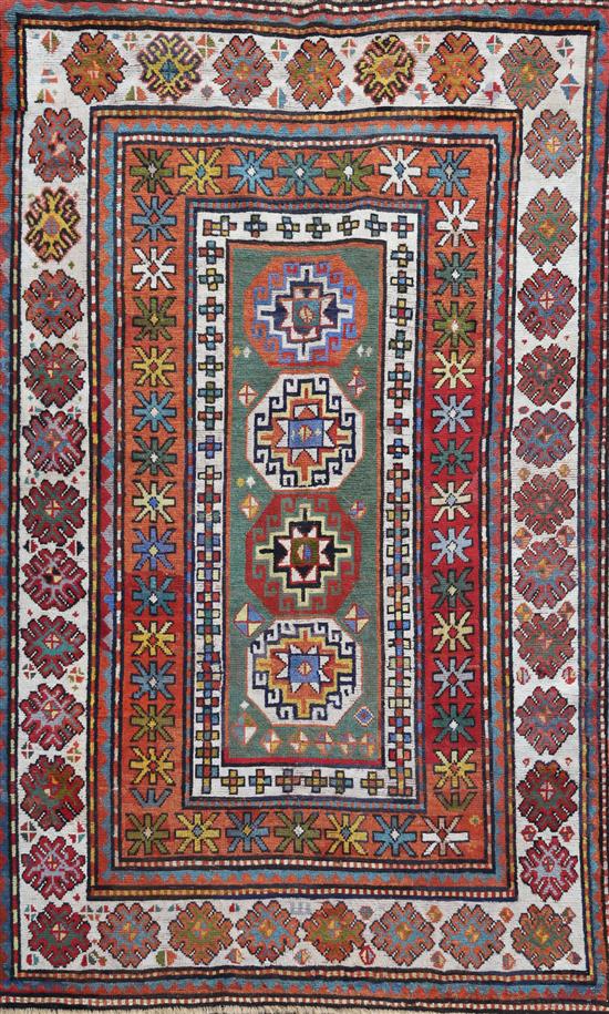 An antique Caucasian polychrome ground rug, 7ft 3in by 4ft 8in.